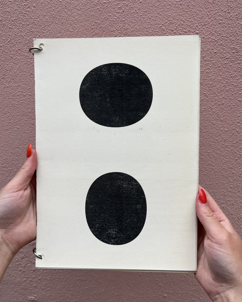 Front cover of a black and white booklet